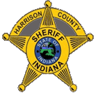 Harrison County Sheriff's badge (Indiana): a gold five-point star with blue center and sheriff seal at the middle.